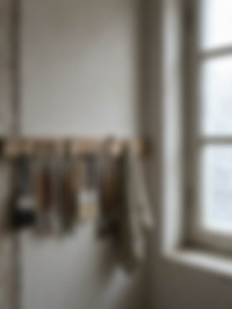 Brushes hanging in a studio, with north light.