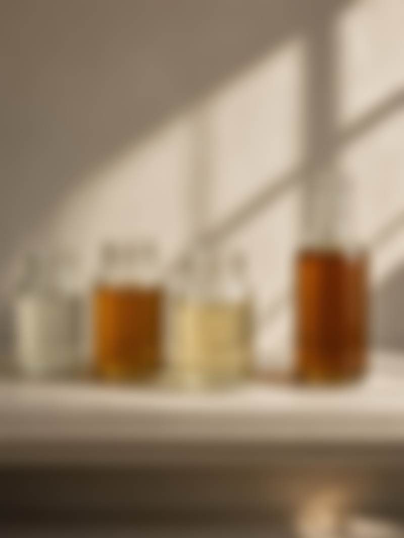 Jars of oil and solvent on a studio shelf.