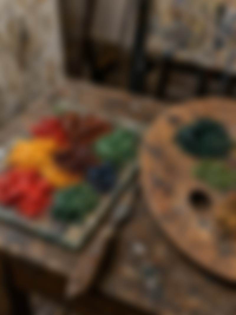 Pigment and a palette knife on a studio table.