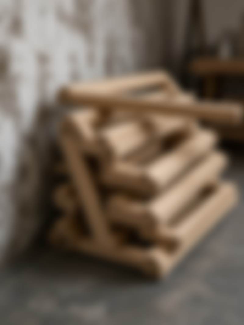Wooden stretcher bars stacked in a studio corner.